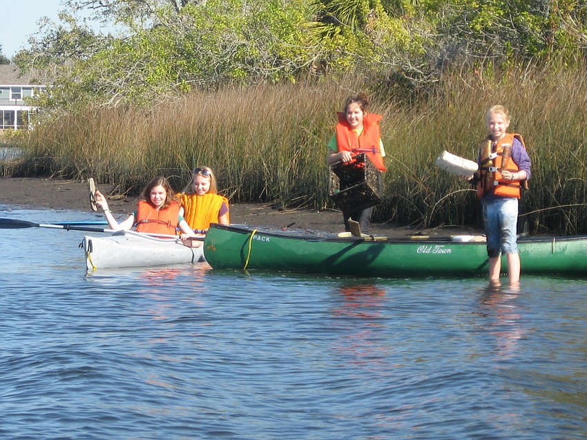 Emma King, Laurel Beukema, Lily King and Lea Beukema used a kayak and canoe pick up discarded items along the shore.
