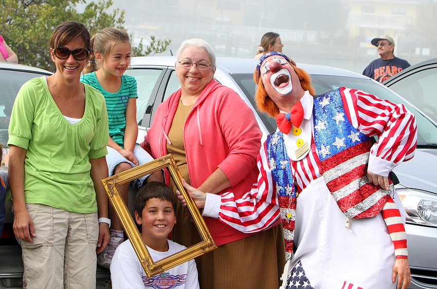 Rhoda, Katie, and Clay Mullet along with Ann Mast have some fun with Chuck Sidlow the Clown prior to Joseph Bauerâ€™s circus stunt.