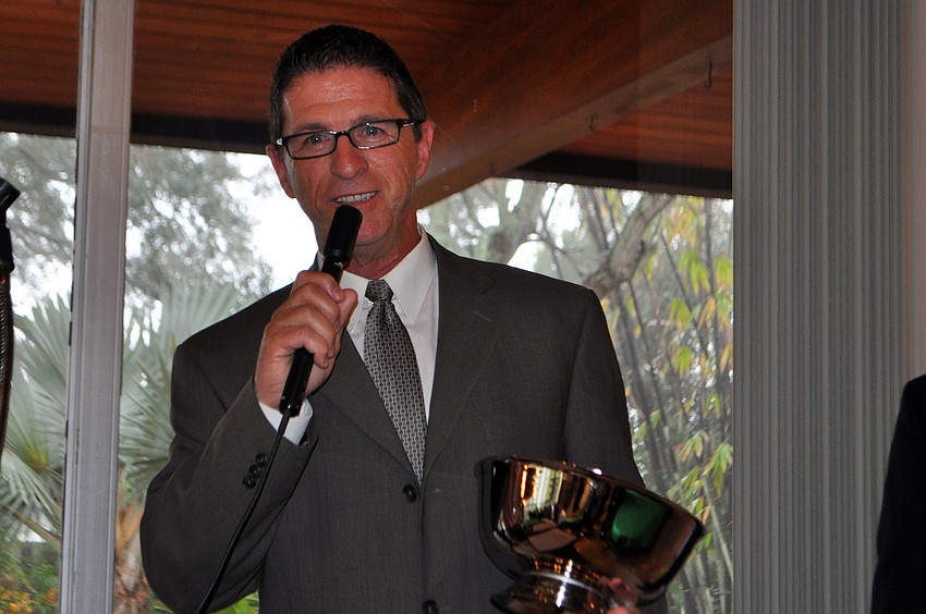 Vice President of property management for One Sarasota Tower, Earl Fossum, accepts the Silver Bowl Award.