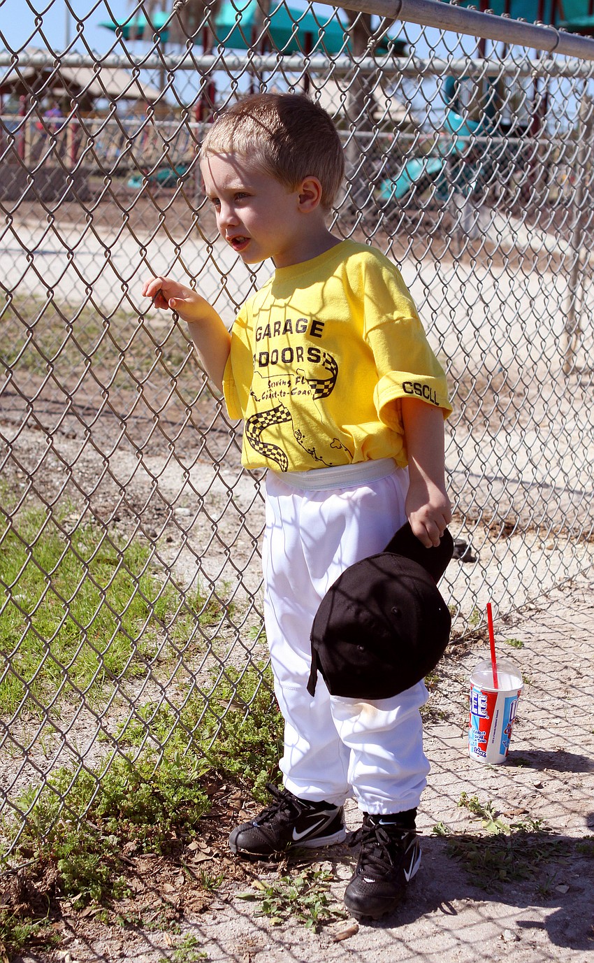 Aiden Zingel, 4, watches the tee ball game before his game on Saturday, Feb. 19 at Twin Lakes Park during Central Sarasota Little League Opening Day.