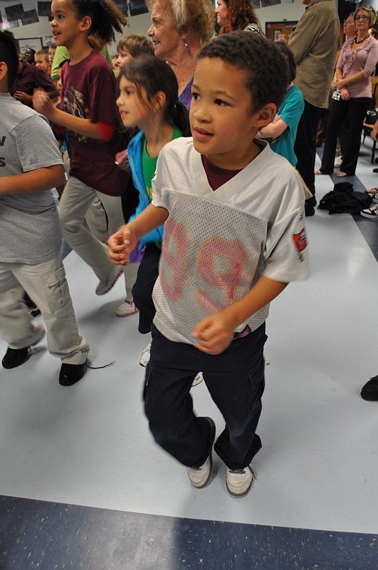 Ira Beville, 7, followed Gerald McCoy's lead in exercising.