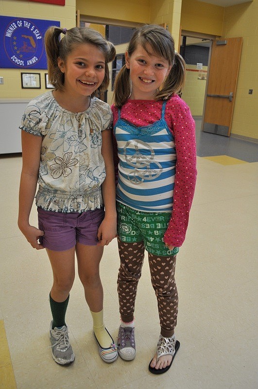 Fourth-grade student Anjolie Berninger, pictured with fifth-grader Sofi Anderson, donned mismatched green and yellow socks to show support for the Green Bay Packers.