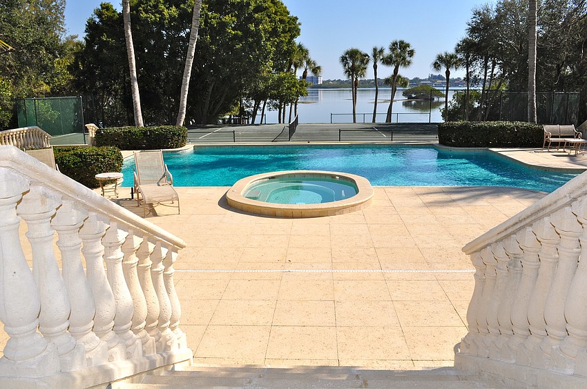 Magical Beachfront Mansion: The estate features a Har-Tru tennis court, manicured putting green, outdoor chessboard and covered boat slips.