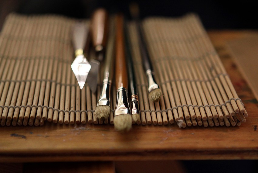 David Leffel's paint brushes and tools lay out on his work table during a break in the workshop on Monday, Feb. 21, at Longboat Key Center for the Arts.