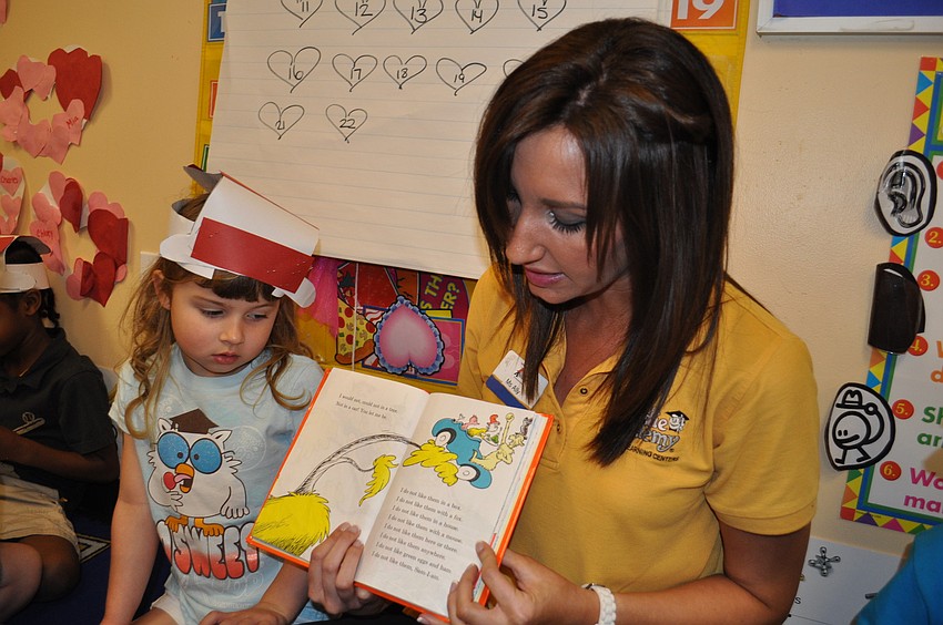 Five-year-old Nyah Andrews sidled up to teacher Ally Vitale as she read one of Dr. Seussâ€™s books to the class.