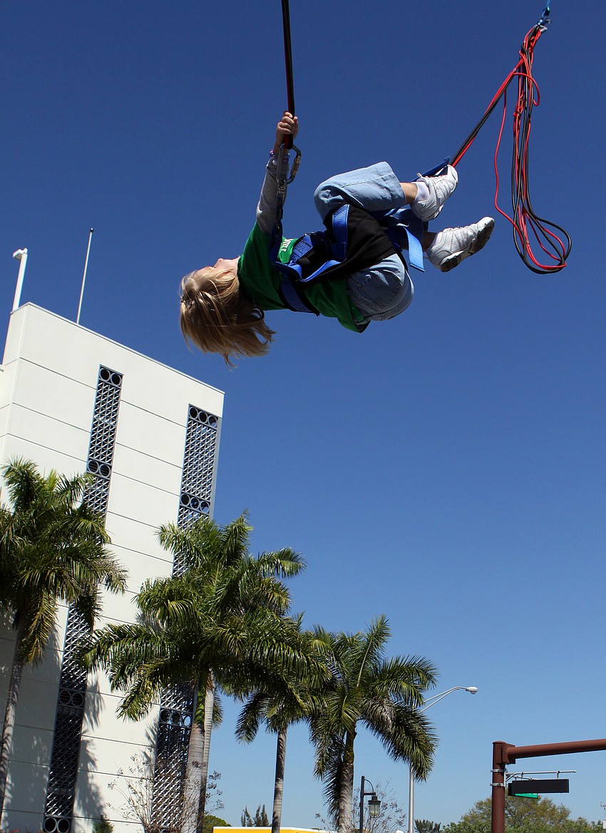 Sierra Smith, 7, has fun on the eXtreme jump! and even does a backflip on Saturday, March 12 at the Sham Rock Festival on Hillview.