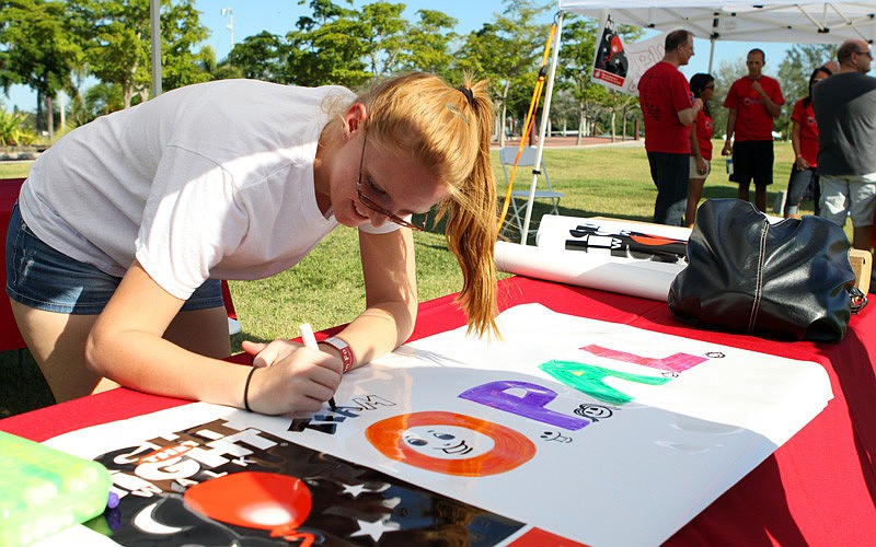 Opus Brown makes a banner for her team.