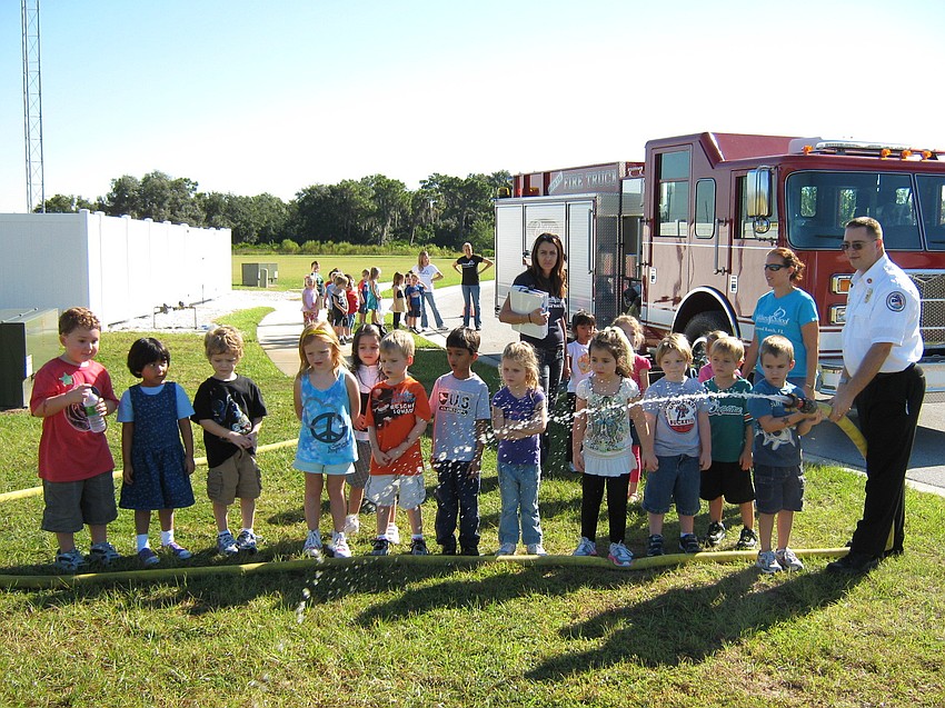 Children even got to help hold the fire hose as part of the dayâ€™s festivities.