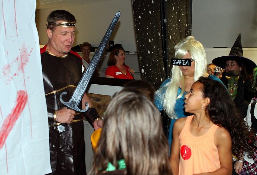 Hercules, Doug Preston, hands out candy to some of the girls from Girls Inc.