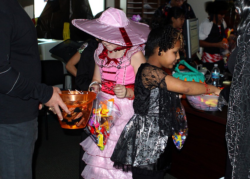 Shelby Witkowski and Trinity Villalta get their last few pieces of candy before leaving UBS.