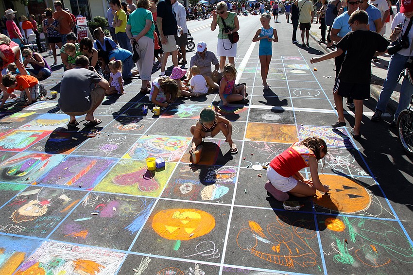 Children work on their mini masterpieces as part of the chalk quilt at Chalk Festival 2010.