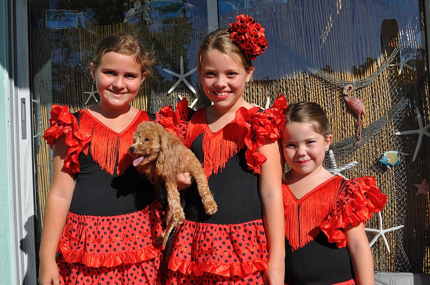 Anne Patrolla and Ava and Ellie Caflisch dressed as flamenco dancers.