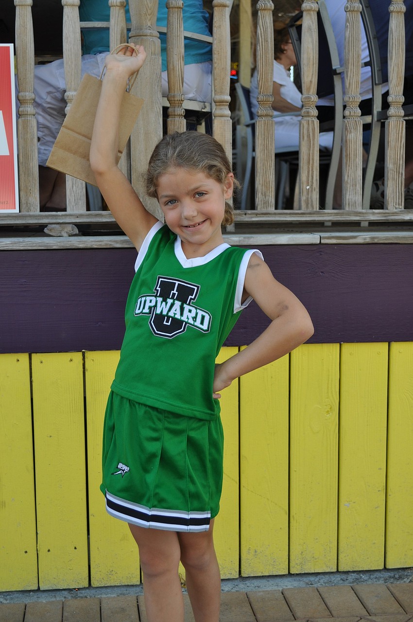 Makenzie Fleming, age 7, strikes a pose in her cheerleader costume.