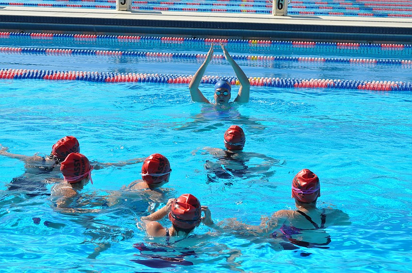 The SASSY girls get some instruction from a Gators Synchro Team member.