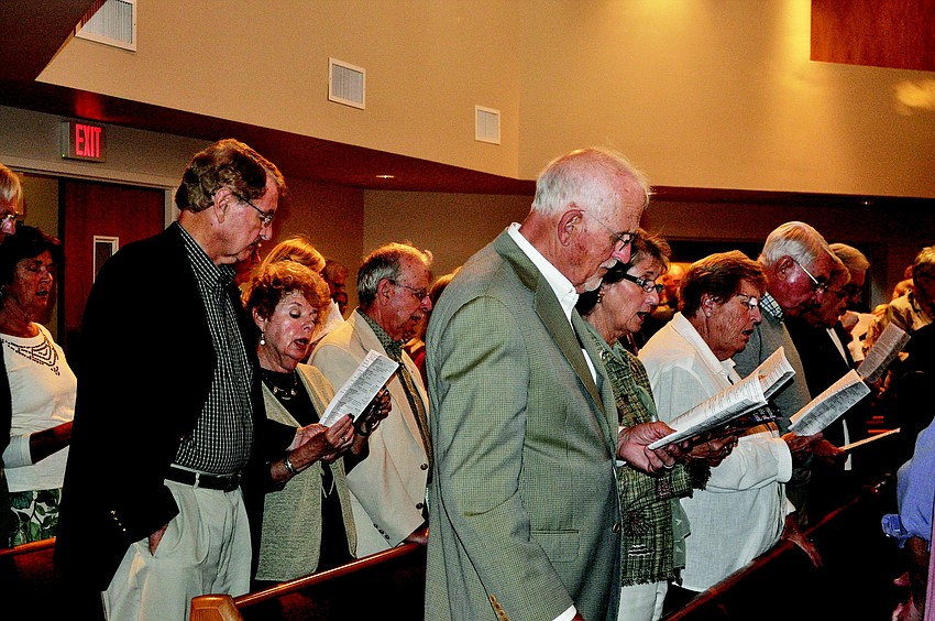The congregation, made up of members from all six area houses of worship, sings together.