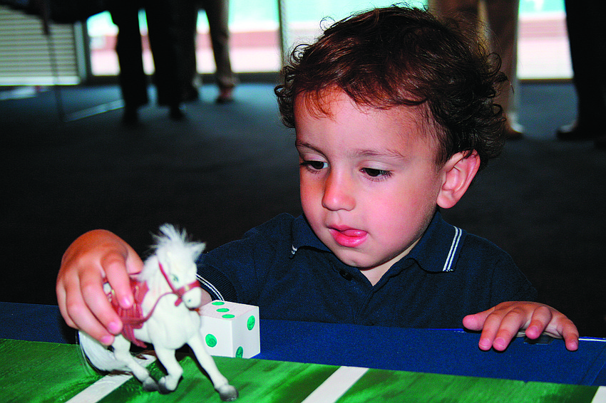 Tripp Taylor plays the Derby game at Bird Key Yacht Club's Fourth of July party.