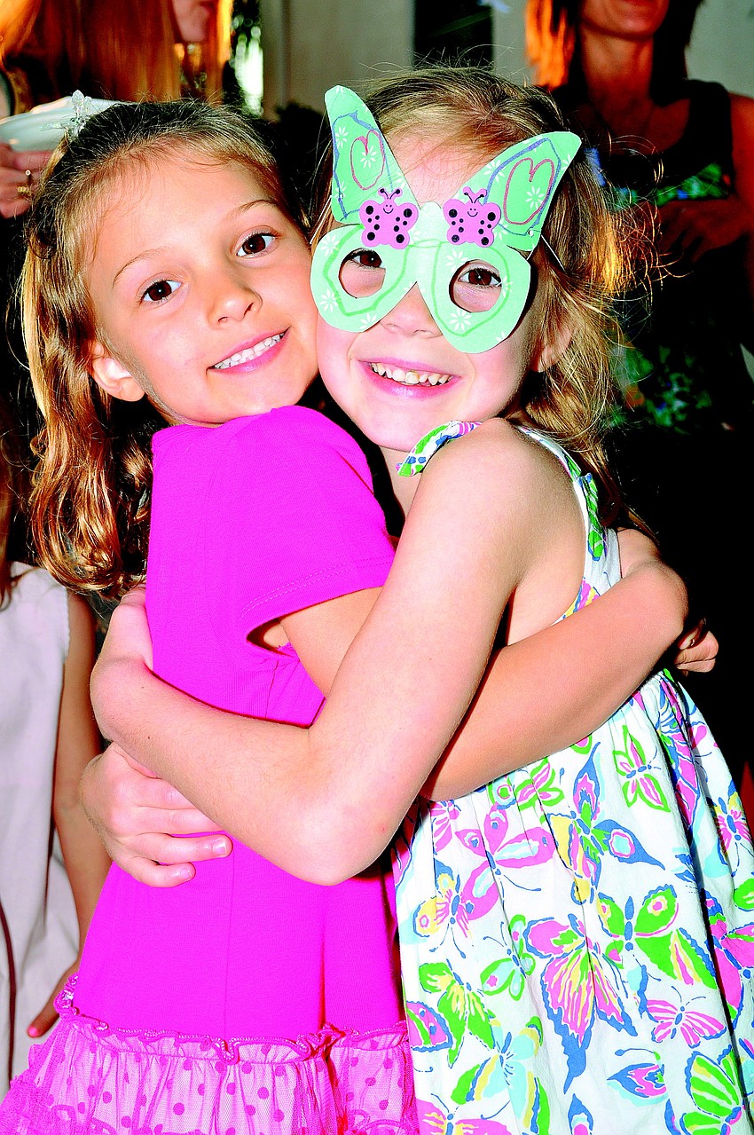 Ella Menke and Ella Wicks hug in March at First Presbyterianâ€™s Butterfly Ball.