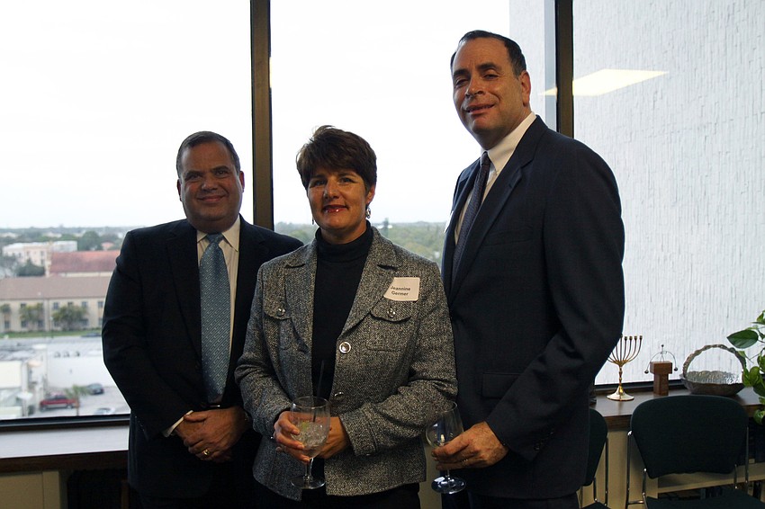 Stuart Siegel, Jeannine Germer and Jim Gerber enjoy themselves at AJCâ€™s Grand Opening of their new office Thursday evening in the Bank of America Building.