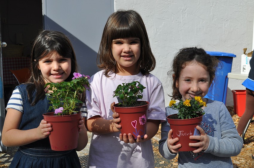 Julia Steinbach, Riley Silva and Felicia Wetsman plan to give their flower pots to family members.