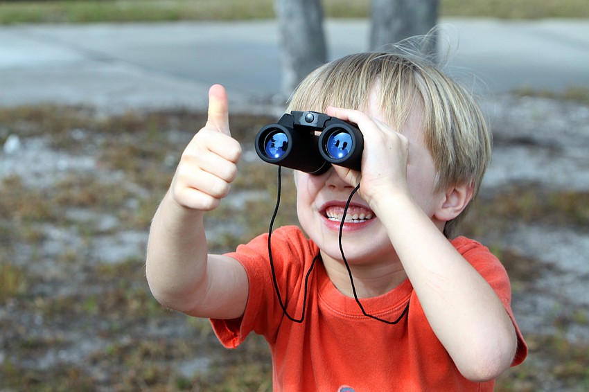 Aiden Theis excitedly waits to see the circus stunt that took place at 11:30 a.m. on Tuesday on the roof of Watergate Condominium.