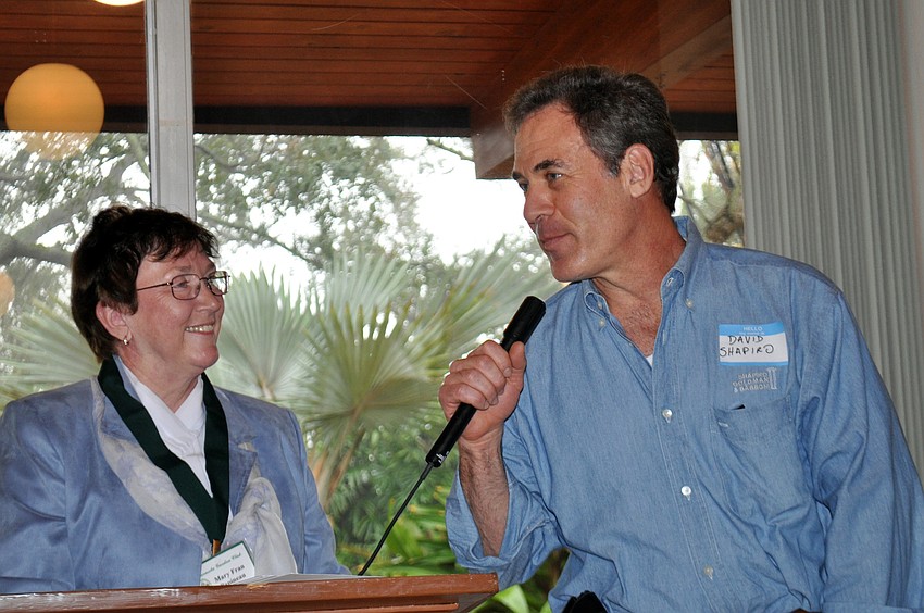 Mary Papineau presents David Shapiro with a certificate of recognition for Shapiro, Goldman, Babboni & Walsh Law Firm's Cocoanut Avenue office.