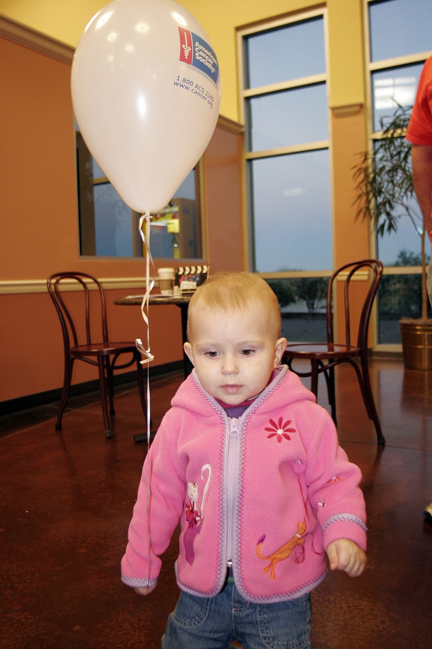 Ayva Thoenes, 16 months, couldn't stop playing with her balloon.