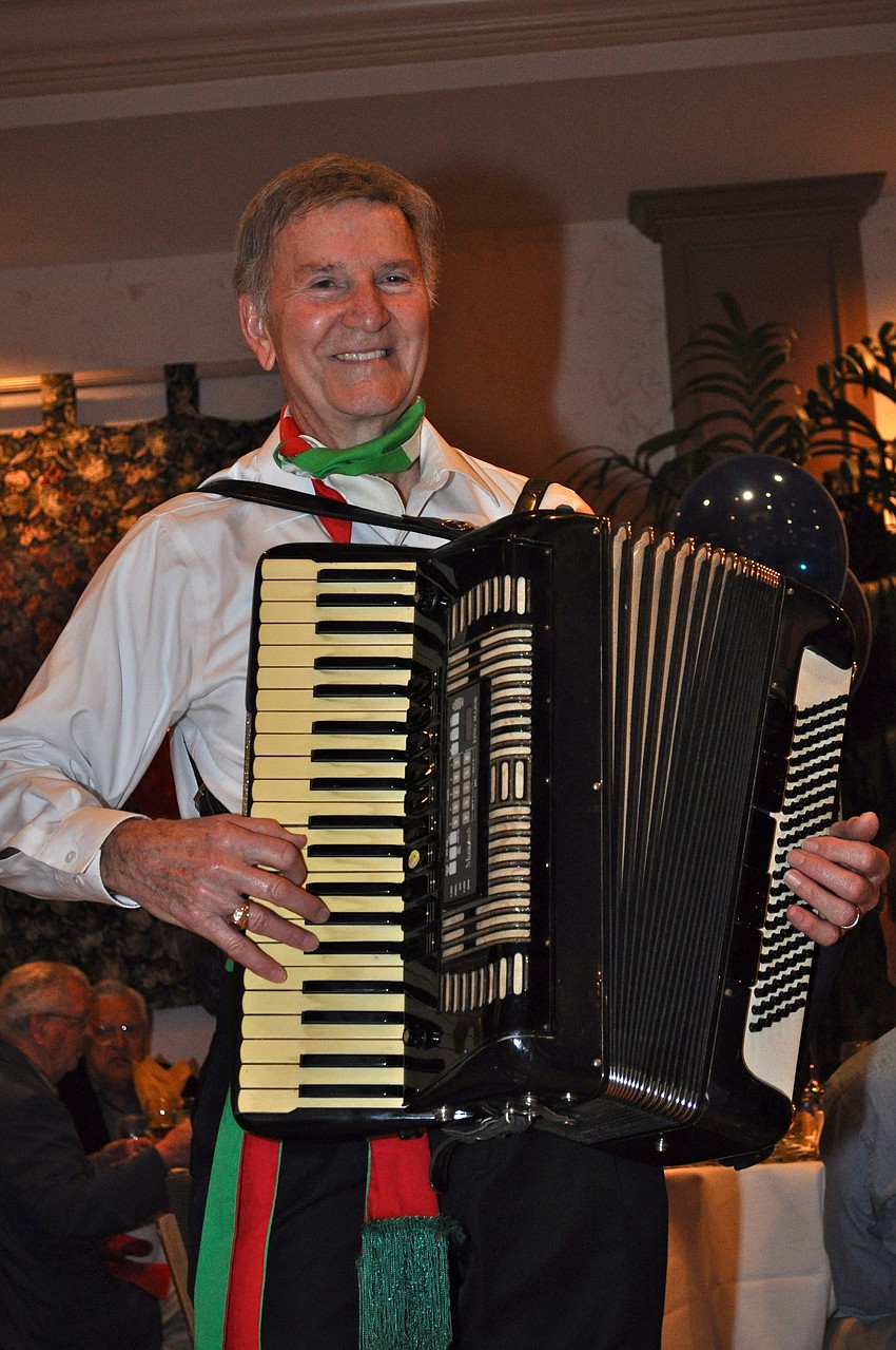Mario De Leon entertains the group with tunes on his accordion.