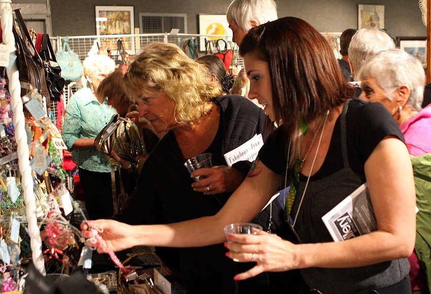 Artist Kari Bunker shows Joyce Colletti her work on Thursday, Feb. 10 at the Fabulous Arts Boutique.