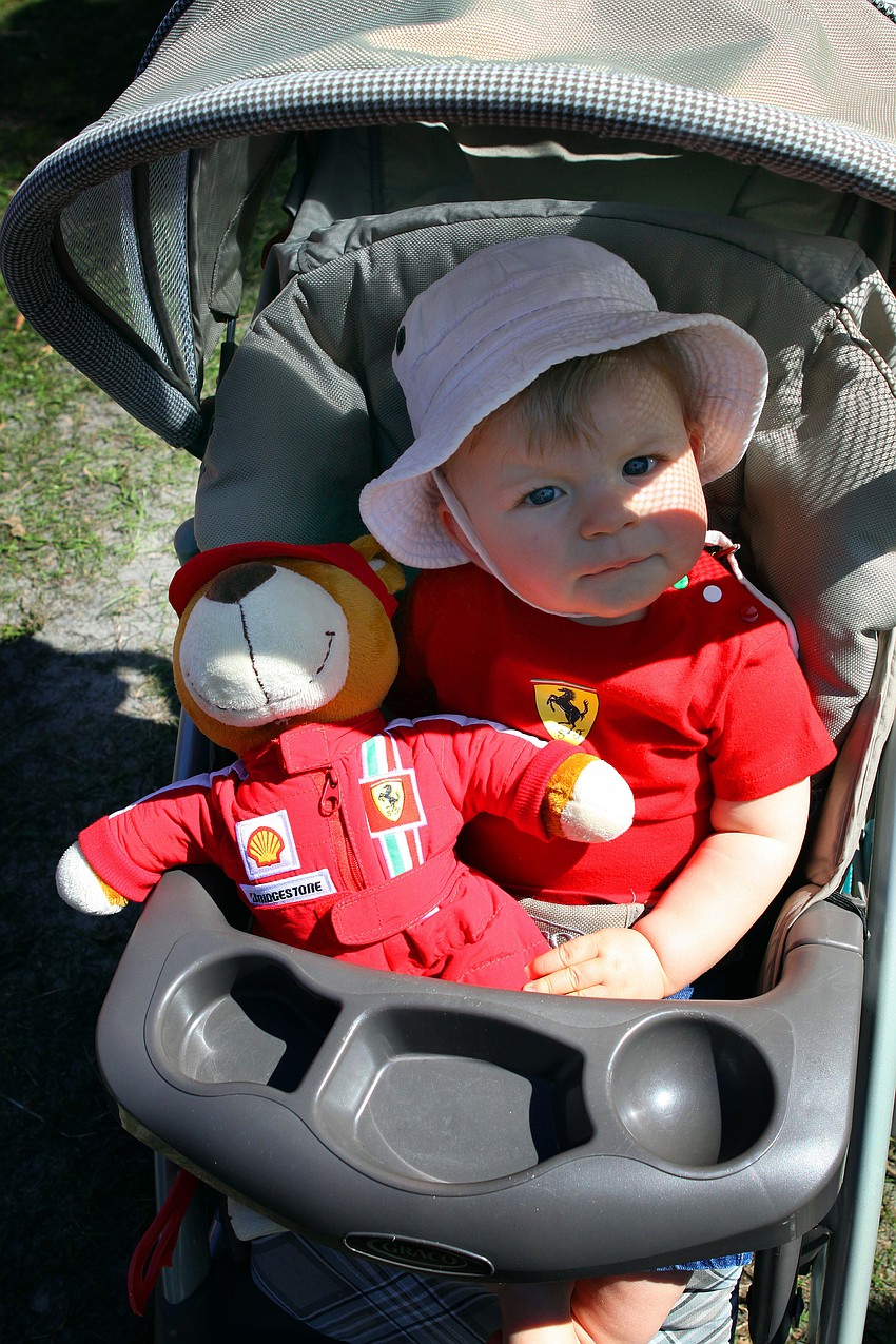 Zalan Guilbert, 8 months, with his bear on Saturday, Feb. 19 at the Sarasota Exotic Car Fest in St. Armand's Circle
