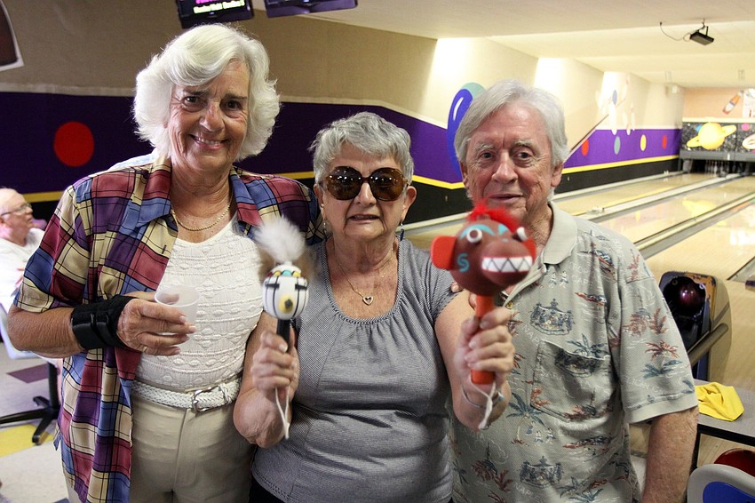 Maureen Morris, Vicky Urban and Ron Bledsoe of BKYC pose together while Urban shows off the 