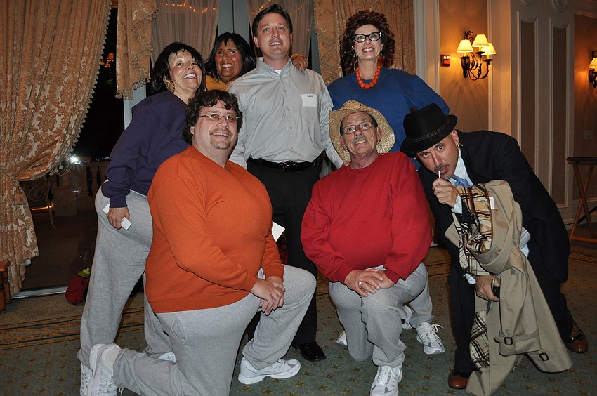 The Murders She Wrote cast gathered around Kevin Foust, who won a foursome golf outing for his guess of who 