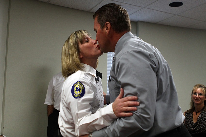 Deputy Chief Sandi Drake kisses her husband, Billy.