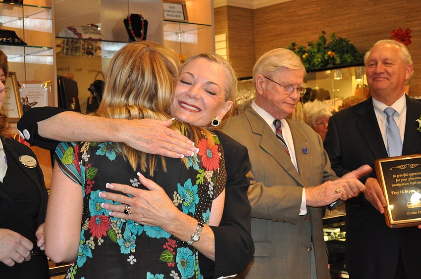 Sally Rose Gruters and Jean Weidner of Designing Women Boutique embrace after Gruters presents the boutique with an award from the Sarasota Chamber of Commerce.