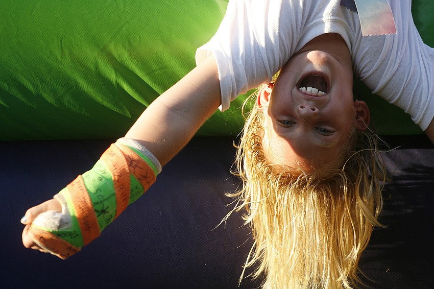 Savannah Barron, 8, had a blast hanging upside-down during the picnic.