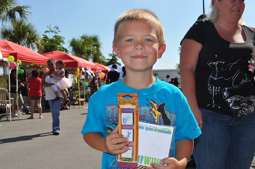 Harlee Murray shows off his prizes from miniature golf