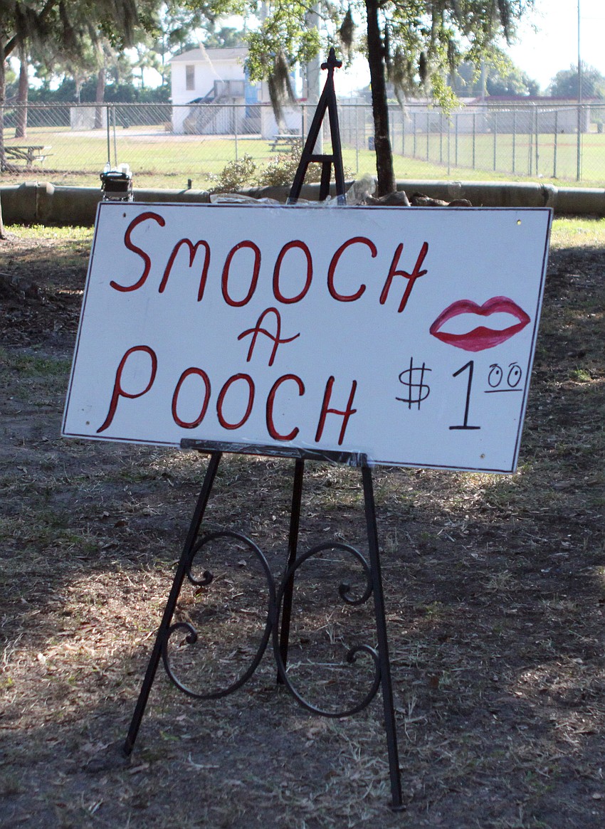 The sign for the â€œSmooch A Poochâ€ table.