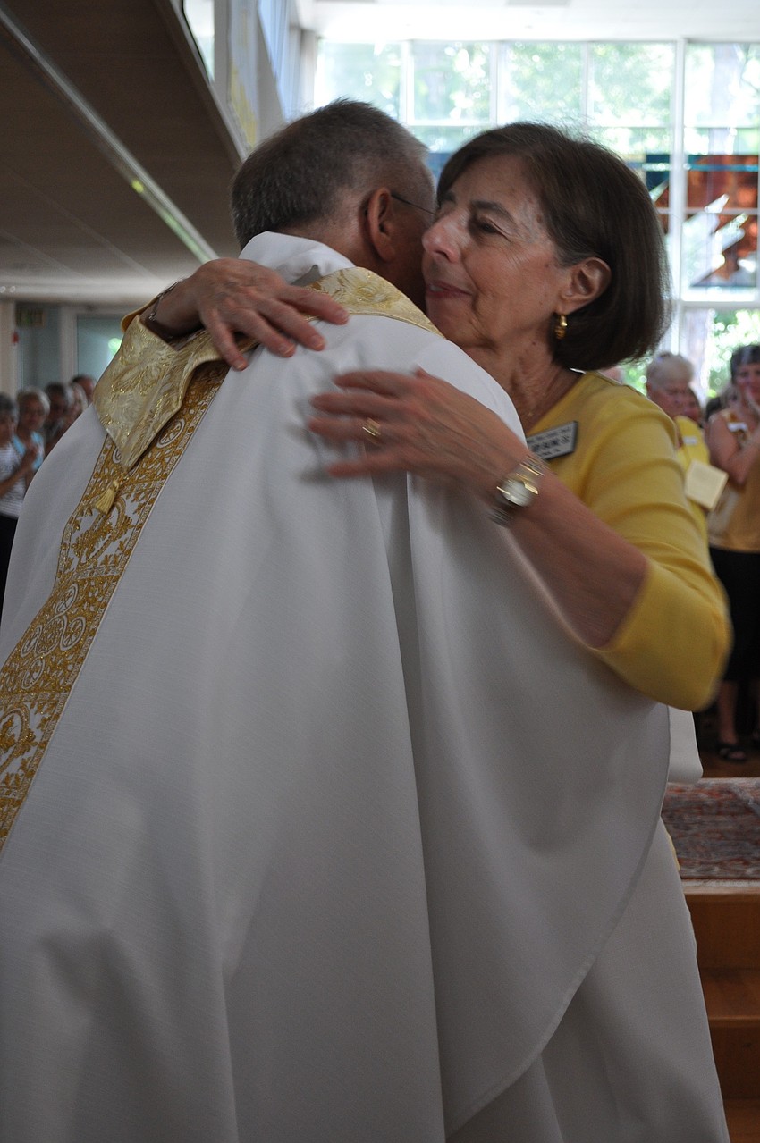 Father Henry and Baldino embrace