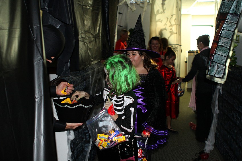 Girls get more candy as they exit the Merrill Lynch haunted house.