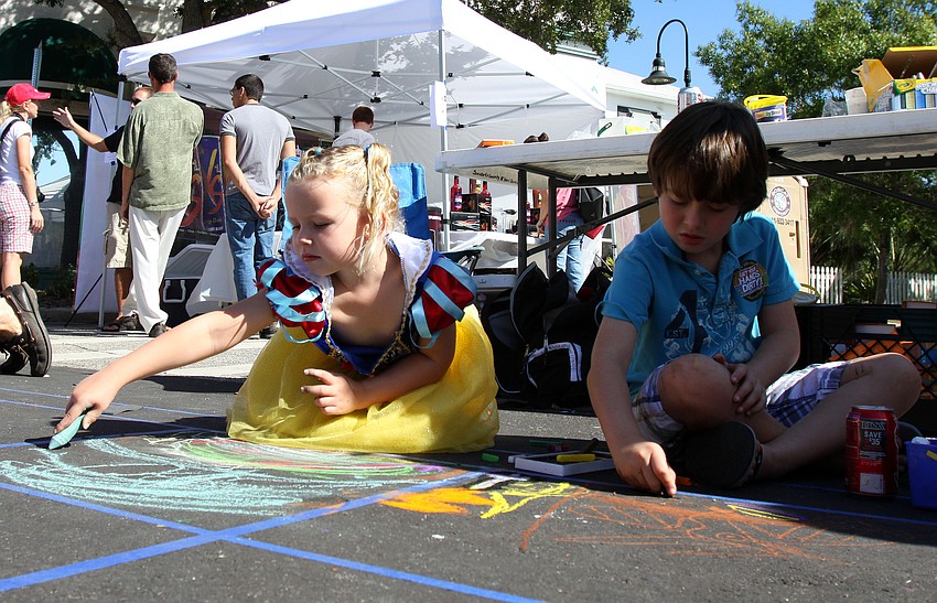 Lily, Snow White, 4, and Jake Frank, 7, work on their chalk drawings for the chalk quilt.