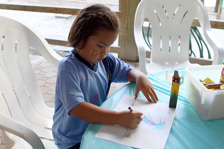 Hannah Rudo, 5, colors a picture of a pelican at the second birthday party for the Save Our Seabirds facility.