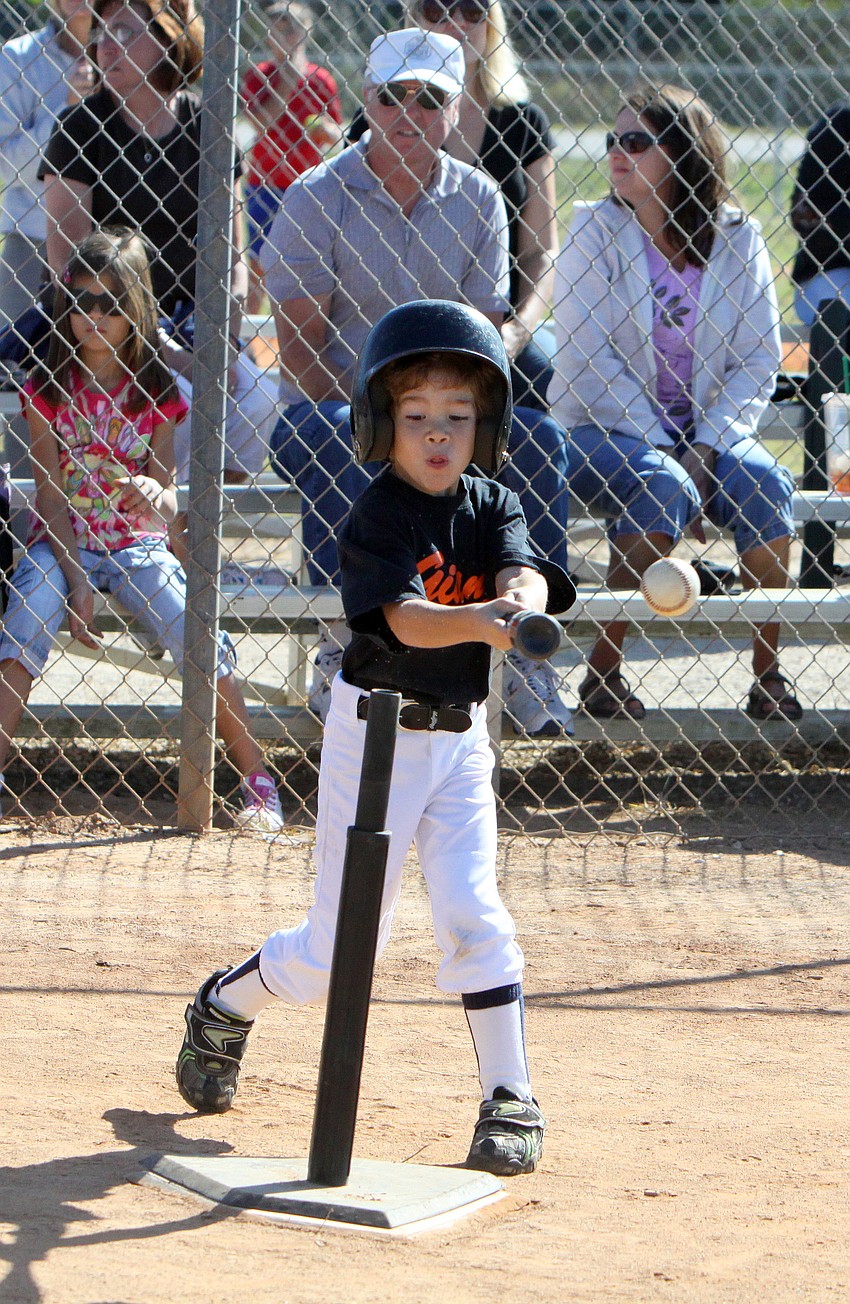 Giants player hits the ball off the tee during the game against the Pirates.