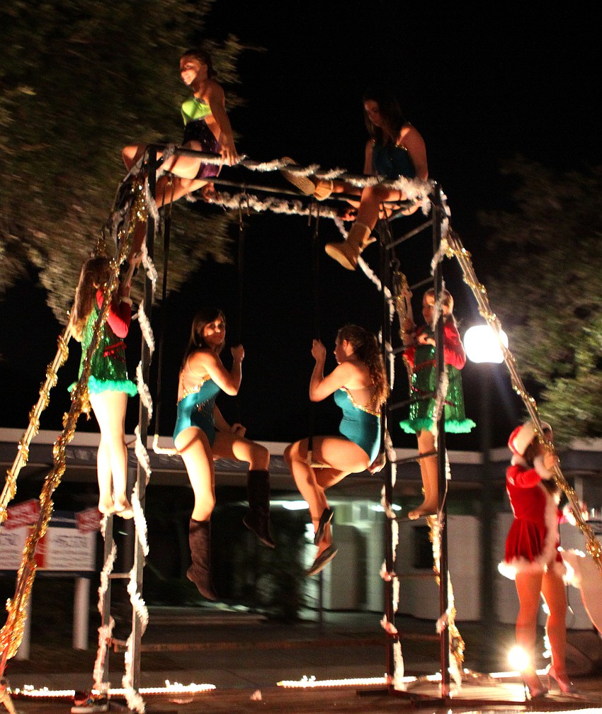 Some of the Sailor Circus kids wave from the Sailor Circusâ€™ float as it makes its way down Main street.