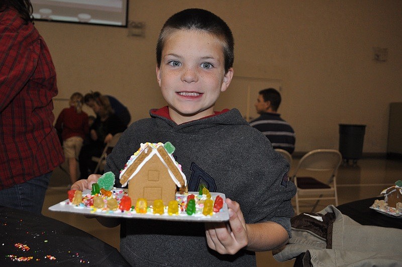 Kanaan Harvey, 6, liked adding the gummy bears to his gingerbread house.
