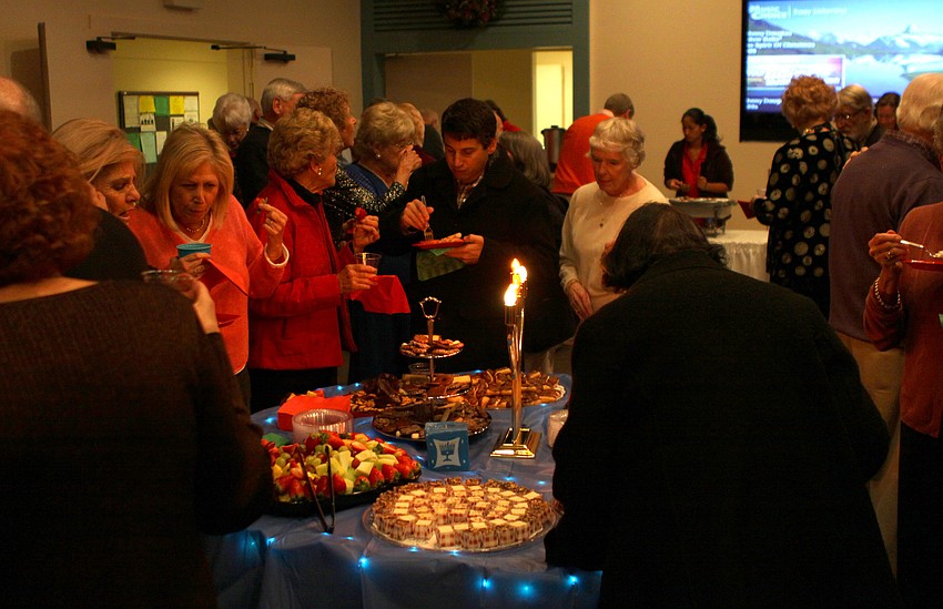 One of the main tables of food was decorated with a Hanukkah theme in mind, including a fake menorah centerpiece.