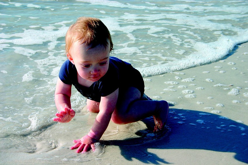 Brisk winds and a chilly water temperature didn't deter 13-month-old Jordan Atkins, who splashed in the Gulf of Mexico surf in January.