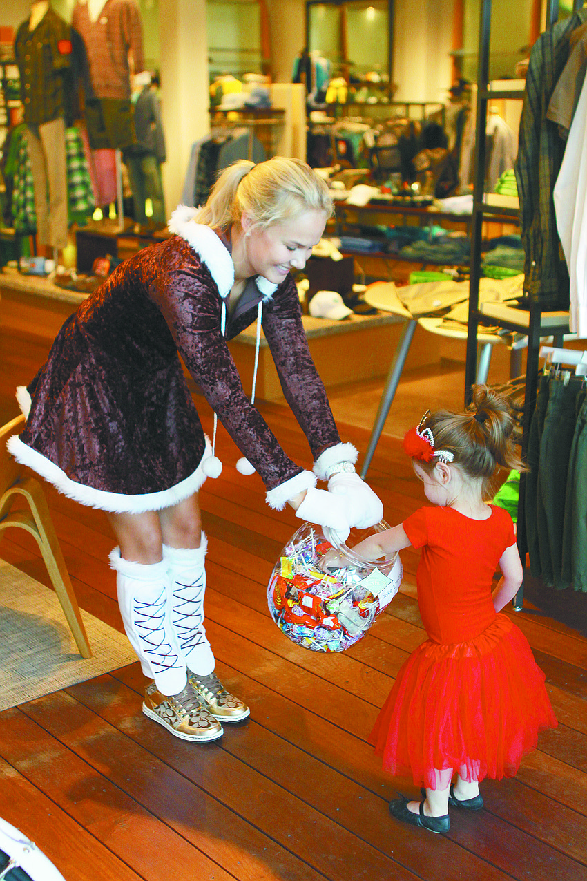 Molly Raff hands out candy to Lillian Beattie during 