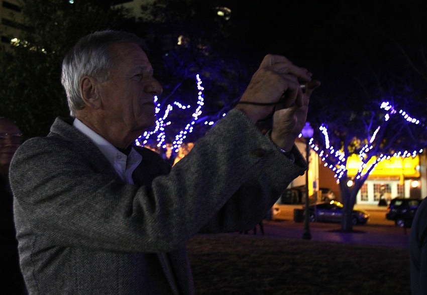 John Moran takes a photo of the tree lighting event on Friday in Five Points Selby Park. Moran was entrusted with managing the LED lighting project.