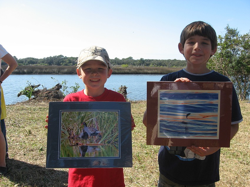 Reid King and his brother Jeb display the pictures they won after they tied for the most unusual items recovered from the river.