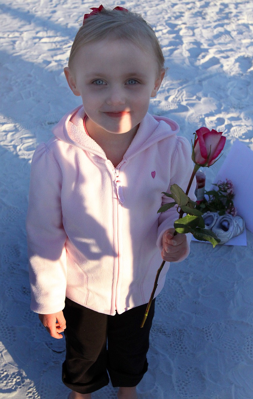 Riley Burns was the flower girl for two vow renewals, her parents and her grandparents, during the Say I Do, Again ceremony, Monday, Feb. 14 on Siesta Key Beach.