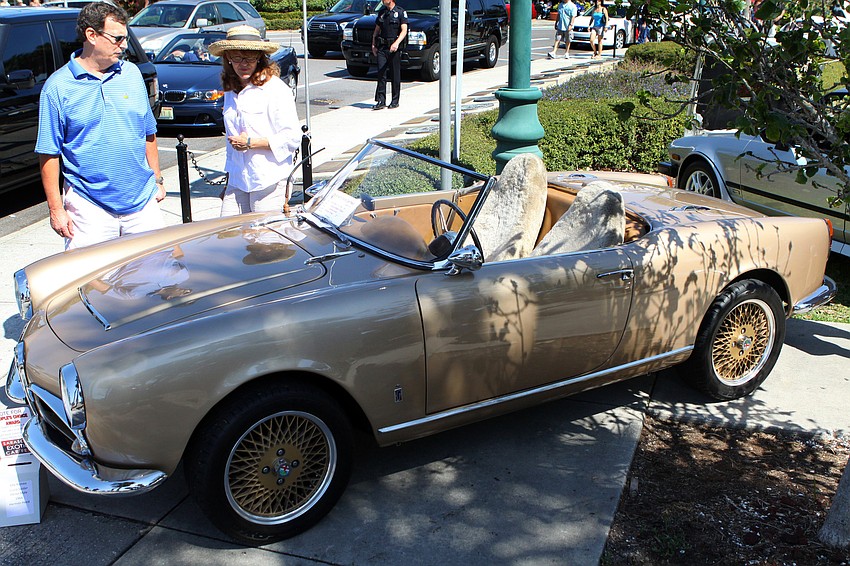 People look at Harmon Heed's 1964 Alfa Romeo Giulia Spider Abnor Male on Saturday, Feb. 19 at the Sarasota Exotic Car Fest in St. Armand's Circle.